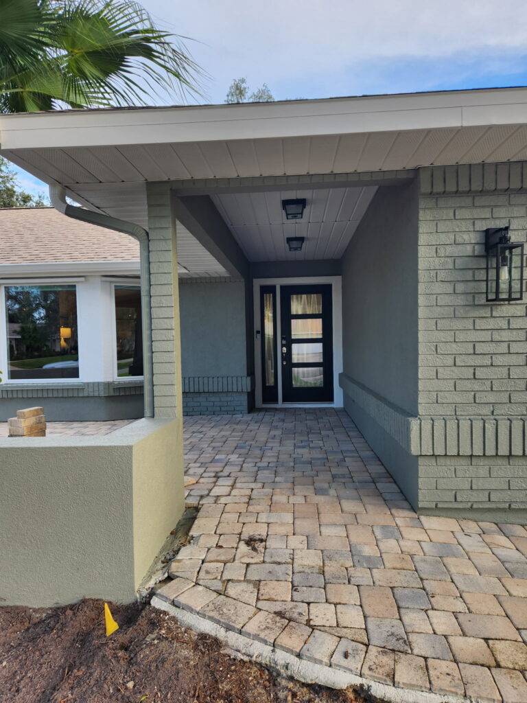Front entry residential painting in Melbourne, FL with clean trim lines and covered porch details by Fresh Finish Custom Coatings.