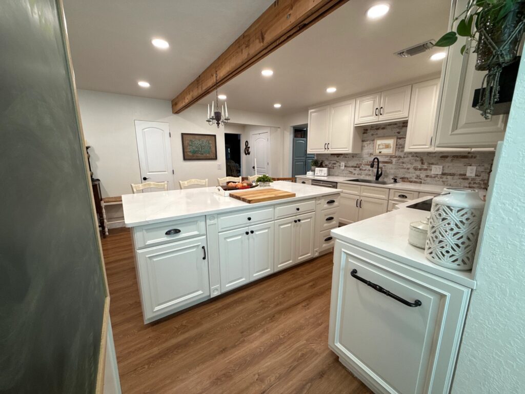 Spacious kitchen with freshly painted light blue cabinets and white countertops in Melbourne FL